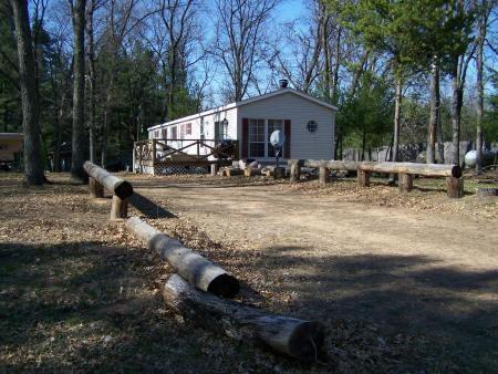 mobile home for sale with a wooded yard