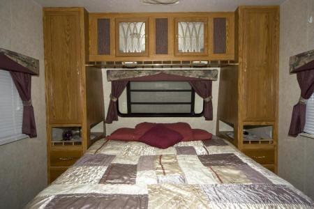 camper bedroom with beautiful cabinetry