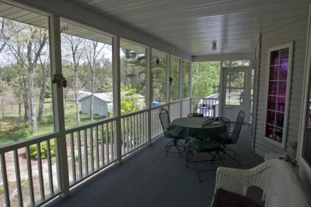 screened in porch with a beautiful view of landscaped backyard