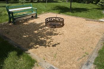 Photo of cozy bench area with fire ring