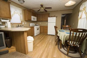 Spacious Kitchen With Wooded Flooring & Cabinetry